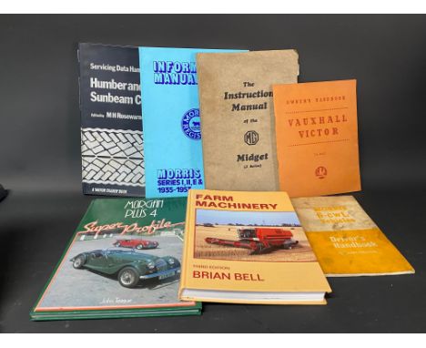 An MG Midget J Series Instruction Manual and six further motoring volumes.