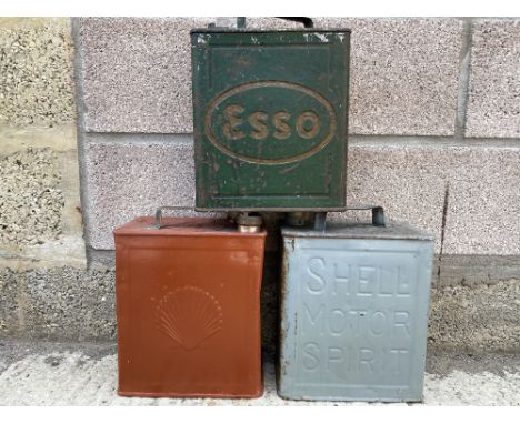 Two Shell two gallon petrol cans, and a third for Esso.