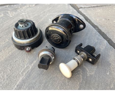 A Lucas type D20 dash lamp, a Smiths cigarette lighter and two switches.