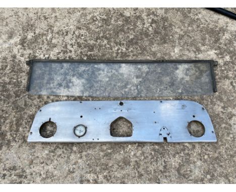 An alumnium fronted dashboard with Morris Motors Eureka oil pressure gauge inset, plus a partial windscreen, probably Morris.