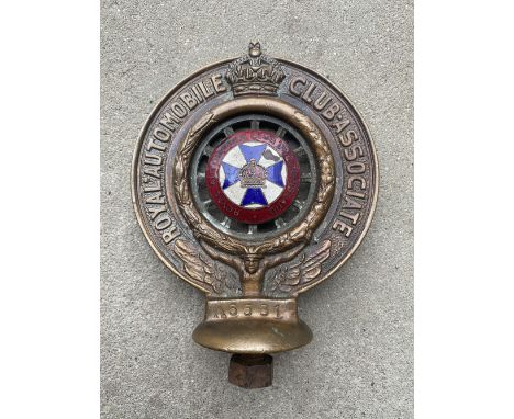 An RAC Associate car badge with Queensland enamel centre, no. A6581.