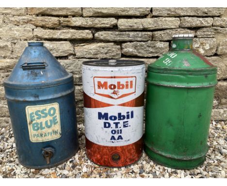 An Esso Blue five gallon drum, a Mobil drum and one other.