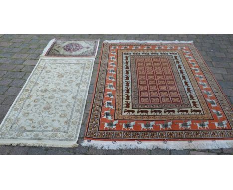 Persian style carpet with stag &amp; stallion motifs 148cm by 205cm, ivory ground runner &amp; a prayer mat