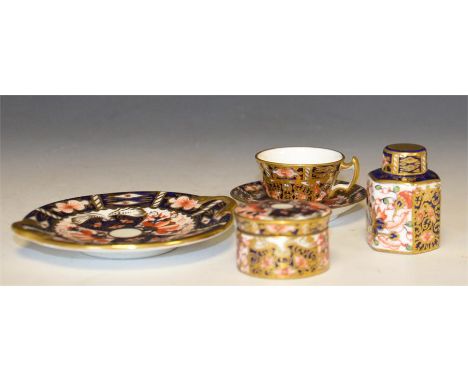 Four Royal Crown Derby miniatures, consisting of cup and saucer, tea caddy, balm pot and side plate. Circa 1915. Height of ta