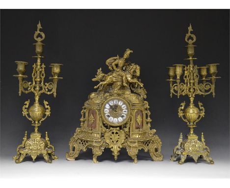 A French brass three piece mantle garniture set, consisting of a clock and two candelabra. 20th Century, (3)