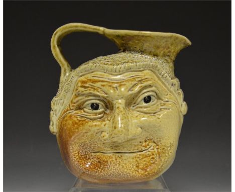 An Antique (Over 100 years old) Martin Brothers barrister face jug, sculpted in relief to both sides with faces and a barrist