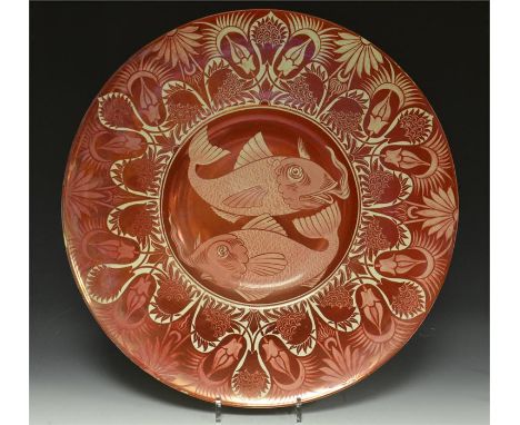 A large William De Morgan ruby lustre charger, decorated with character fish and floral border. Back decorated with ruby lust