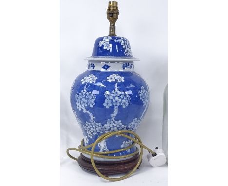 An Oriental blue and white ceramic table lamp on wooden plinth, height 42cm overall 