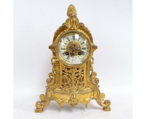 A brass-cased 8-day mantel clock, enamel dial with Roman numeral hour markers, striking on a bell, case height 33cm 