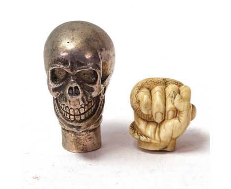 A 19th century carved ivory hand holding snake parasol handle tip, and a silver plated skull walking cane handle, largest hei