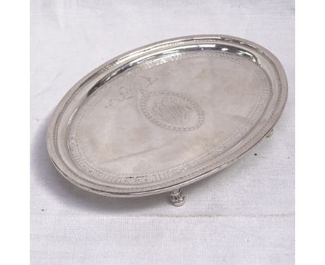 A George III oval silver teapot stand, with bright-cut decoration on 4 scrolled feet, by Thomas Chawner, London 1786, width 1