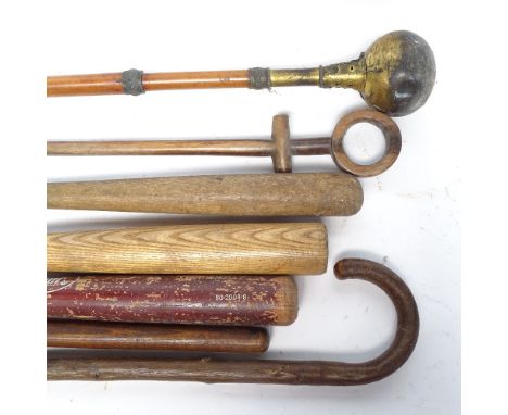 Various canes and sticks, including a long ceremonial brass orb sceptre in a painted metal stick stand 