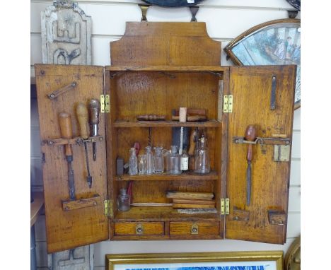 A Victorian panelled oak carpenter's tool cabinet, with label for Sheffield Works, and some tools 