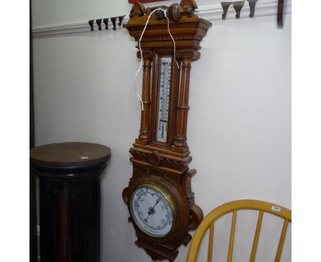 An Edwardian carved oak-cased aneroid wall barometer and thermometer, with brass presentation plaque by Members of the Staff 