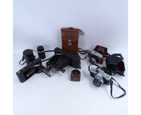 A collection of various Vintage cameras, including folding Ensign, Yashica, and Minolta 