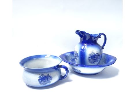 A wash jug and basin and matching chamber pot, with printed riverside house design 