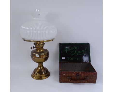 A Vintage lithographed tin Maison Lyons Toffee briefcase box, and a brass oil lamp with milk glass shade and chimney,  box le