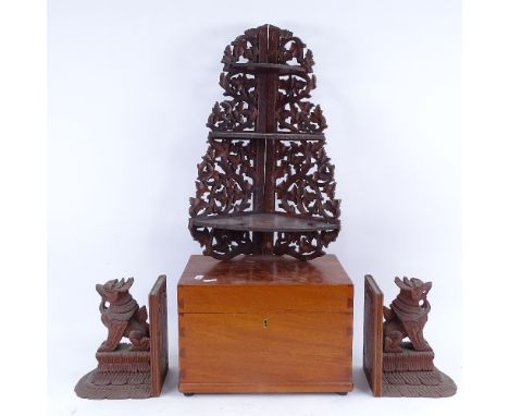 A pair of Oriental carved hardwood bookends, a graduated 3-tier corner hanging shelf, and a satinwood sewing box (4) 