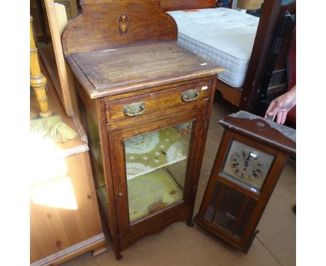 An Edwardian banded mahogany music cabinet with glazed door, W50cm, D35cm, H126cm, and a 1920s 3-train mantel clock, L74cm 