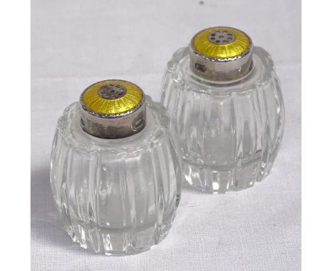 A pair of glass barrel design pepperettes with silver and yellow enamel mounts, by Hugo Grun, Copenhagen, height 5cm 