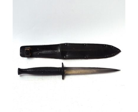 A Fairbairn-Sykes Commando fighting knife, and leather scabbard, blade length 15cm 