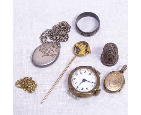 An unmarked gold and gold plated stick pin in the form of a horse's head, a silver locket and thimble, a delicate 9ct gold ch