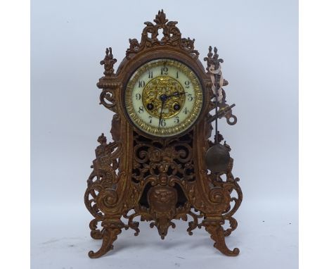 A painted cast-iron 8-day mantel clock, enamel dial with pendulum and key, height 36cm 