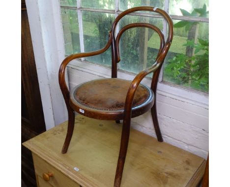 An early 20th century child's bentwood armchair, label for J R Roberts Stores Ltd London 