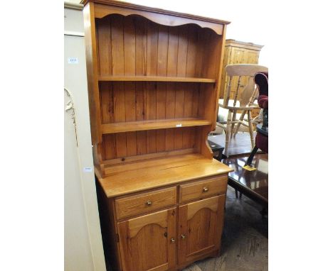 A modern pine shelf back kitchen dresser