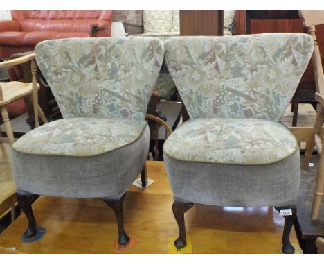 A pair of unusual vintage triangular backed upholstered low chairs