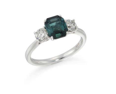 An 18ct white gold tourmaline and diamond three stone ring,&nbsp;the central octagonal step cut green tourmaline with a brill