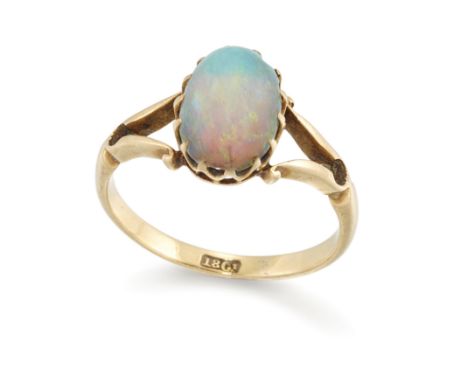 An early 20th century single stone opal ring, the oval cabochon opal to split shoulders and a plain hoop, stamped 18ct, ring 