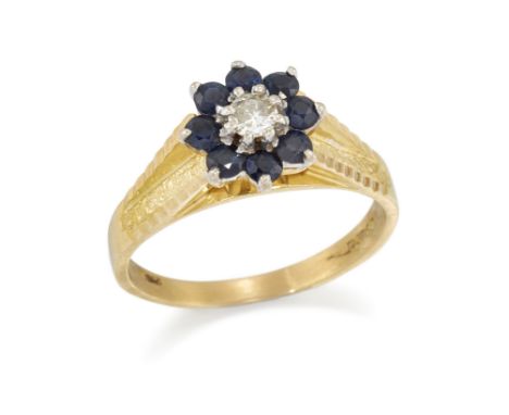 An 18ct gold diamond and sapphire cluster ring, the brilliant cut diamond centre within circular cut sapphire surround, to ta