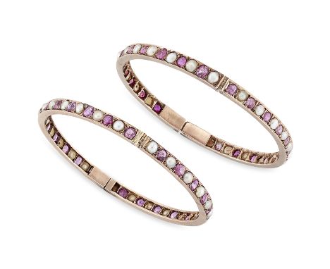 A pair of ruby and pearl bangles, each with a continuous row of alternating pearls and mixed cut rubies, to box catch and saf