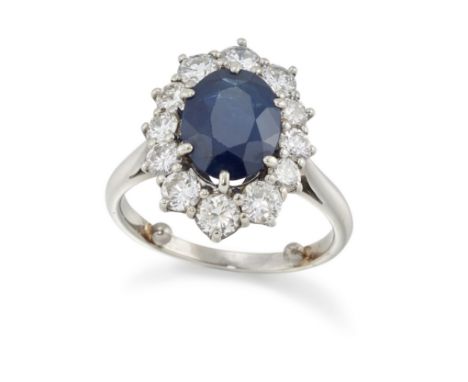 A sapphire and diamond cluster ring, the oval mixed cut sapphire with an estimated weight of approximately 2.30 carats, withi