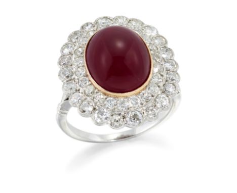 A ruby and diamond cluster ring,&nbsp;the oval cabochon ruby to two row brilliant cut diamond surround, to split shoulders an
