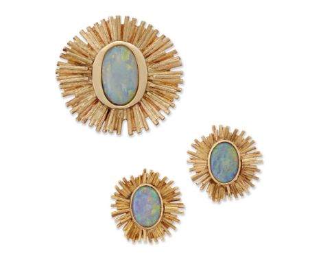 An opal brooch and earclips, the brooch with an oval cabochon opal bezel set to a textured bar sunburst surround, stamped 14k