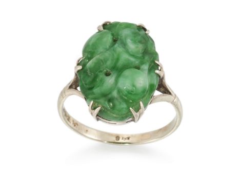 A carved jade single stone ring,&nbsp;the carved jadeite jade cabochon, claw set to a plain hoop, stamped 9, ring size KPleas