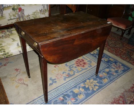 A good 19th c. Pembroke Table standing on tapering square legs and having curved drop leaves and a drawer to one end with bra