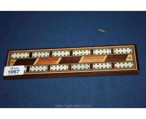 An early 20th c. Mahogany Cribbage board inlaid with satinwood, boxwood and other woods.
