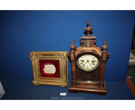 A wooden mantle clock (a/f) and a gilt picture frame.