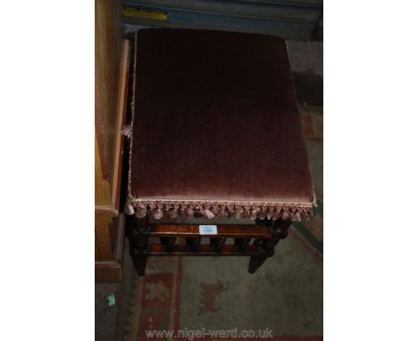 An unusual arts and crafts bobbin turned detail mixed hardwoods Piano/music Stool having a lower music shelf and tasselled de