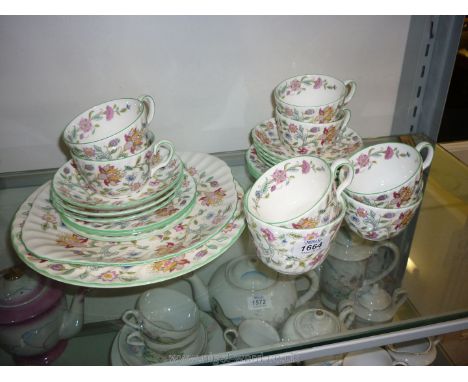 A Minton ''Haddon Hall'' Teaset including seven cups and saucers, six tea plates, sugar bowl, two plates and two candle holde