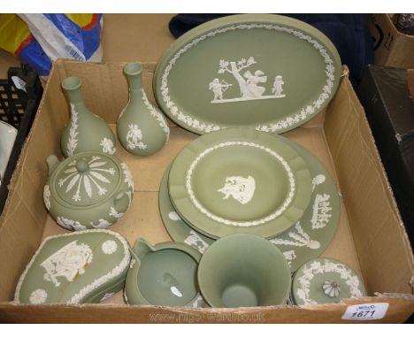 A quantity of green Wedgwood Jasperware including four plates, two small vases, three lidded trinket bowls and a small jug/ur