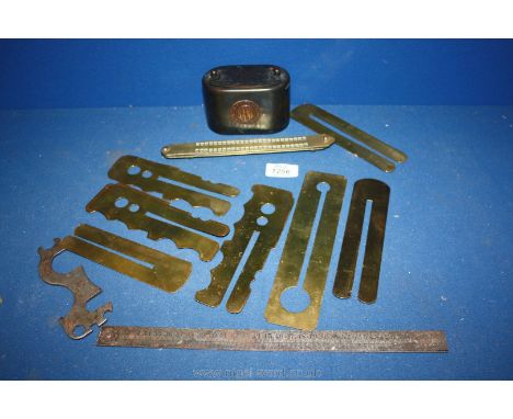 A small quantity of Brass including Brass button shields, a Birmingham Bank money box, a metal ruler and a bicycle spanner.