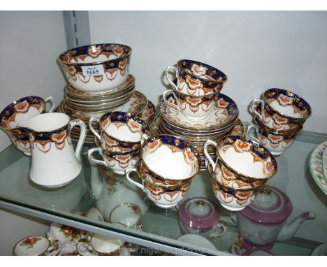 A Royal Albert Crown china including thirteen cups, twelve saucers, twelve tea plates, milk jug, sugar bowl and bread and but