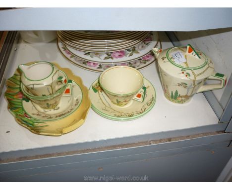 A "Norman" Art Deco part Teaset decorated with cottage garden and a Carlton Ware "Australian" design bowl.