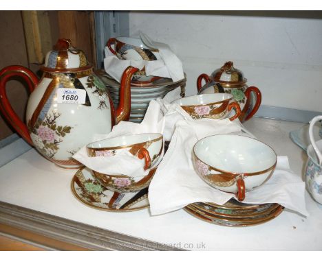 A Japanese porcelain Teaset including teapot, sugar bowl, two sandwich plates, eight tea plates, nine saucers and seven cups,