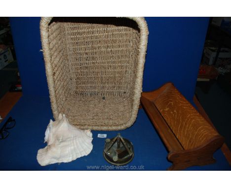 A wicker basket, 'Globe Wernicke' book trough, trench art ashtray and a large Shell.