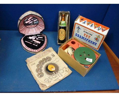 A child's Chad Valley record player (in original box), a manicure set in a pink heart-shaped box and a 1950's Guinness advert